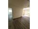 Bright living room features a seamless layout with modern gray wood-look floors at 3412 Townhouse Dr, Las Vegas, NV 89121