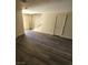 Comfortable living room boasting modern gray wood-look floors and abundant light at 3412 Townhouse Dr, Las Vegas, NV 89121