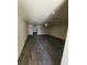 Open living room featuring modern gray wood-look flooring and ample natural light at 3412 Townhouse Dr, Las Vegas, NV 89121