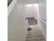 Carpeted stairs lead upward, illuminated by natural light from a nearby window at 3412 Townhouse Dr, Las Vegas, NV 89121