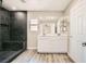 Beautiful bathroom with a black tiled shower and double vanity with modern fixtures at 3437 Visionary Bay Ave, North Las Vegas, NV 89081