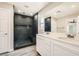 Bathroom featuring a sleek black tiled shower and double vanity sinks at 3437 Visionary Bay Ave, North Las Vegas, NV 89081