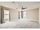 Spacious carpeted bedroom with a modern ceiling fan, large windows, and neutral paint at 3437 Visionary Bay Ave, North Las Vegas, NV 89081