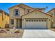 Two-story home with tan siding, desert landscaping, a two-car garage, and a tile roof at 3437 Visionary Bay Ave, North Las Vegas, NV 89081