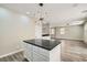 Modern kitchen island with a black countertop and an open floor plan at 3437 Visionary Bay Ave, North Las Vegas, NV 89081
