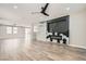Open-concept living room with hardwood floors, recessed lights, and an electric fireplace at 3437 Visionary Bay Ave, North Las Vegas, NV 89081