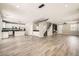 Open-concept living space featuring stylish floors, modern lighting, and a staircase at 3437 Visionary Bay Ave, North Las Vegas, NV 89081
