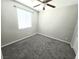 Neutral bedroom with plush carpeting, a ceiling fan, and a window with blinds at 3708 Fuselier Dr, North Las Vegas, NV 89032