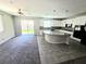 Bright and spacious kitchen and living area featuring granite countertops and a sliding glass door at 3708 Fuselier Dr, North Las Vegas, NV 89032