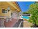 Covered back patio featuring tiled floors and access to the refreshing swimming pool at 4280 Cicada Way, Las Vegas, NV 89121