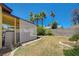 Expansive backyard features a covered patio, palm trees, and block wall fencing at 4280 Cicada Way, Las Vegas, NV 89121