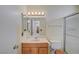 Bright bathroom with a single vanity, toilet, and shower with a glass door and window above at 4280 Cicada Way, Las Vegas, NV 89121