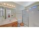 A view of the bathroom with a single sink, toilet, shower, and frosted window at 4280 Cicada Way, Las Vegas, NV 89121