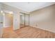 Bright bedroom featuring wood-look floors and a sliding mirror closet at 4280 Cicada Way, Las Vegas, NV 89121