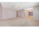 Large bedroom with neutral carpet, ceiling fan, and sliding mirrored closet doors at 4280 Cicada Way, Las Vegas, NV 89121