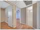 Hallway with hardwood floors leading to bedroom with ceiling fan and ensuite bathroom with shower and tub and black and white tile floor at 4280 Cicada Way, Las Vegas, NV 89121