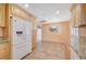 Kitchen featuring wood cabinets, white appliances, and an adjacent dining area at 4280 Cicada Way, Las Vegas, NV 89121