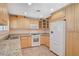 Stylish kitchen featuring stainless steel appliances, granite countertops, and wood cabinets at 4280 Cicada Way, Las Vegas, NV 89121