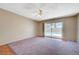 Spacious living room features a sliding glass door with backyard pool view and plush carpeting at 4280 Cicada Way, Las Vegas, NV 89121