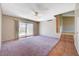 Open living area featuring plush carpet, slider access to the pool, and convenient step-down access to the foyer at 4280 Cicada Way, Las Vegas, NV 89121