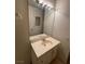 Bathroom vanity featuring a large mirror and a well-lit countertop with a white sink and cabinet storage at 4300 N Lamont St # 232, Las Vegas, NV 89115