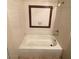 White tiled bathtub and walls feature a brown mosaic-framed inset, adding a touch of elegance to the bathroom at 4300 N Lamont St # 232, Las Vegas, NV 89115