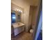 Bathroom featuring a vanity with a sink, a toilet, and a mirror, with a glimpse into an adjacent room at 4300 N Lamont St # 232, Las Vegas, NV 89115