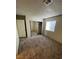 This bedroom has sliding closet doors, neutral walls, carpet flooring and a window with blinds at 4300 N Lamont St # 232, Las Vegas, NV 89115