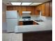Bright kitchen featuring wood cabinetry, white appliances, and ample countertop space at 4300 N Lamont St # 232, Las Vegas, NV 89115