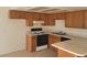 Efficient kitchen layout featuring wood cabinets, white countertop, and modern appliances at 4300 N Lamont St # 232, Las Vegas, NV 89115