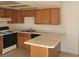 Traditional kitchen with wood cabinets, white appliances, and a breakfast bar at 4300 N Lamont St # 232, Las Vegas, NV 89115