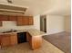 Open kitchen with breakfast bar, wood cabinets, and adjacent dining area at 4300 N Lamont St # 232, Las Vegas, NV 89115