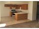 Open kitchen with wood cabinets, a breakfast bar, and seamless transition to the living area at 4300 N Lamont St # 232, Las Vegas, NV 89115