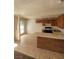 Bright kitchen with wooden cabinets, tile flooring, and a breakfast bar peninsula at 4300 N Lamont St # 232, Las Vegas, NV 89115