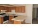 Traditional kitchen with wood cabinets, white appliances, and a breakfast bar at 4300 N Lamont St # 232, Las Vegas, NV 89115