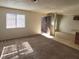 Spacious living room area with neutral walls, carpet flooring, and natural lighting at 4300 N Lamont St # 232, Las Vegas, NV 89115