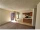 Open-concept living room and kitchen features neutral paint, tile flooring, and carpet at 4300 N Lamont St # 232, Las Vegas, NV 89115