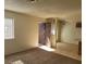 Spacious living room area with neutral walls, carpet flooring, and natural lighting at 4300 N Lamont St # 232, Las Vegas, NV 89115