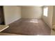 Open living room features neutral walls and carpet flooring, creating a blank canvas at 4300 N Lamont St # 232, Las Vegas, NV 89115