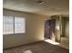 The living room has carpet flooring, neutral walls, and a bright window with blinds to allow natural light at 4300 N Lamont St # 232, Las Vegas, NV 89115