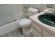 Bathroom featuring a shower with glass doors, a toilet, and a green sink at 4451 Rich Dr # D, Las Vegas, NV 89102