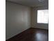 This bedroom has a window for natural light and dark hardwood floors at 4451 Rich Dr # D, Las Vegas, NV 89102