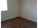 This bedroom has a window for natural light and dark hardwood floors at 4451 Rich Dr # D, Las Vegas, NV 89102