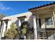 Exterior view of a condo with covered stairways leading to upper-level units at 4451 Rich Dr # D, Las Vegas, NV 89102