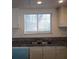 Galley kitchen featuring granite countertops, double sinks, and bright lighting at 4451 Rich Dr # D, Las Vegas, NV 89102