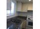 Kitchen boasts granite countertops, a double sink, white cabinets, and a window at 4451 Rich Dr # D, Las Vegas, NV 89102