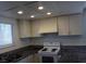 Kitchen featuring white cabinetry, granite countertops, and standard appliances at 4451 Rich Dr # D, Las Vegas, NV 89102