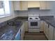 Bright kitchen features neutral cabinets, double basin sink and granite countertops at 4451 Rich Dr # D, Las Vegas, NV 89102