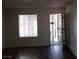 This living room features hardwood floors and natural light from the window and entrance at 4451 Rich Dr # D, Las Vegas, NV 89102