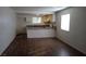 Open-concept living space with wood floors flowing into the bright kitchen at 4451 Rich Dr # D, Las Vegas, NV 89102